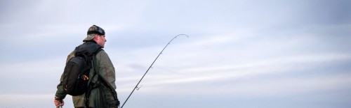 Best 8 Weight Fly Rods You Can Buy Tested - man with 8 wt fly rod on the beach saltwater fly fishing