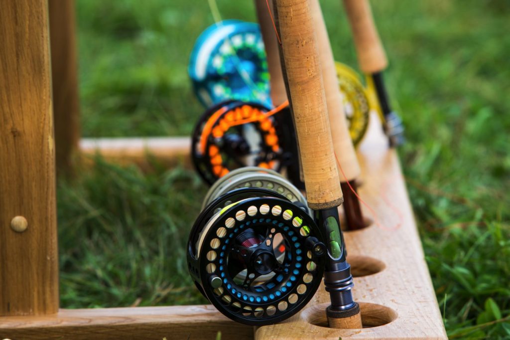 https://intoflyfishing.com/wp-content/uploads/2020/04/Best-Fly-Rod-Combos-Fly-Rods-with-Reels-on-Rack-1024x682.jpg