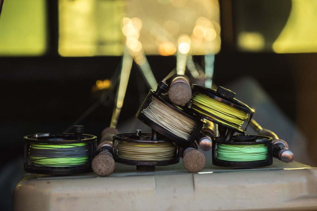 https://intoflyfishing.com/wp-content/uploads/2020/05/Many-Fly-Fishing-Reels-Stacked-Up-1024x683.jpg