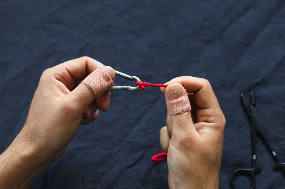 Completed davy knot next to a fly