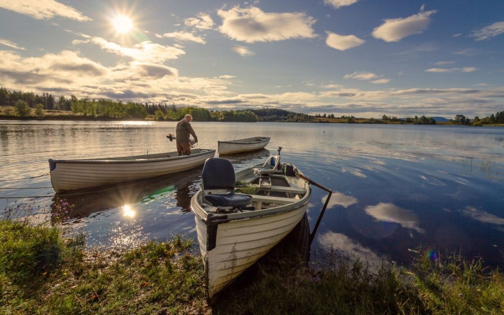 A fisherman is about to leave for fly fishing from a boat