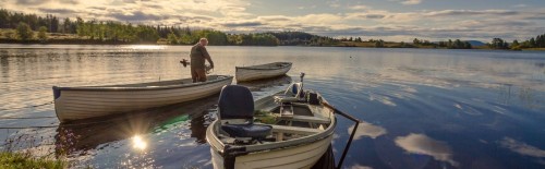 A fisherman is about to leave for fly fishing from a boat