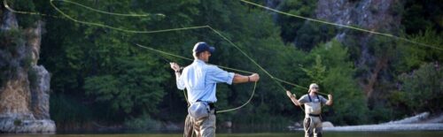 Angler casting a 5 weight fly rod on a trout river