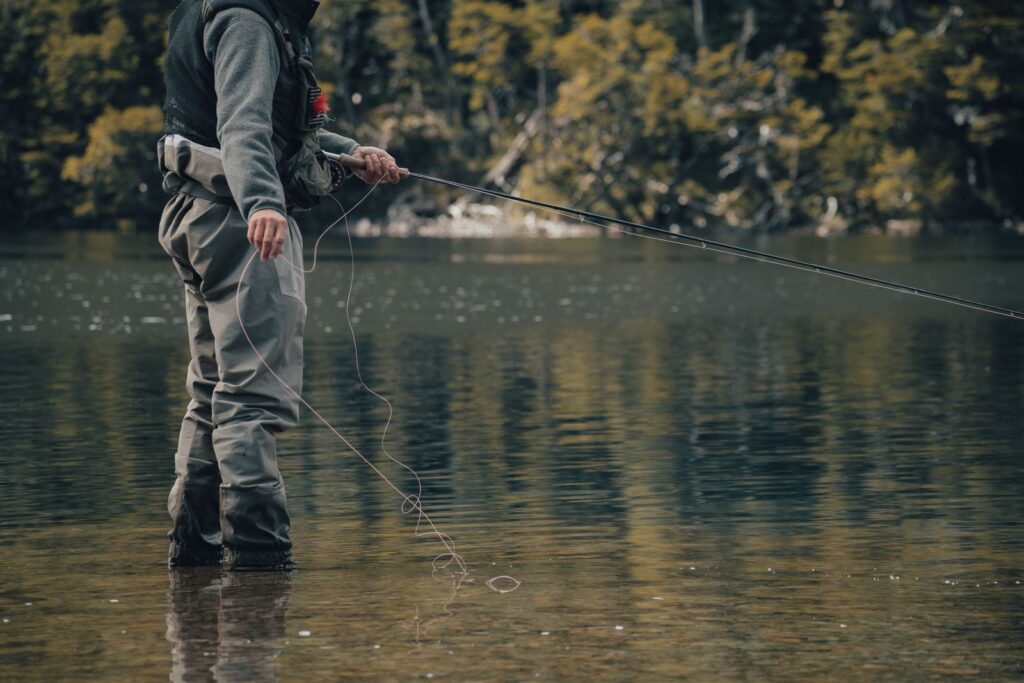 An angler nymphing in a Montana river with a fly rod