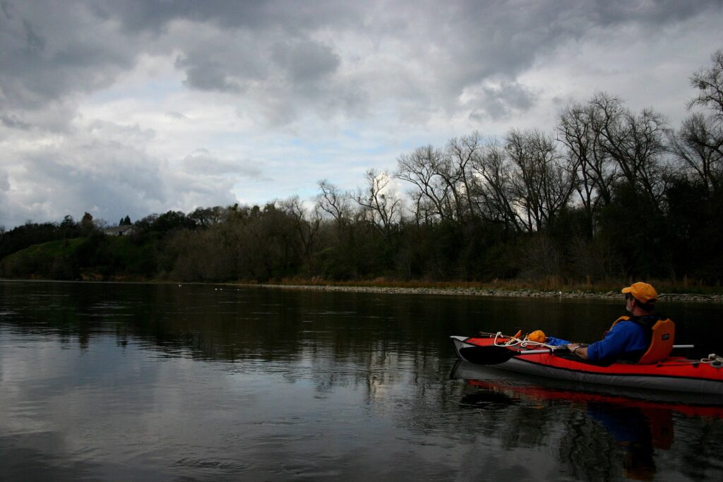 Paddler in a kayak on the lower American River