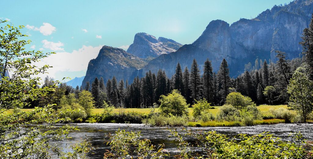 Merced River beneath mountains in Yosemite Valley