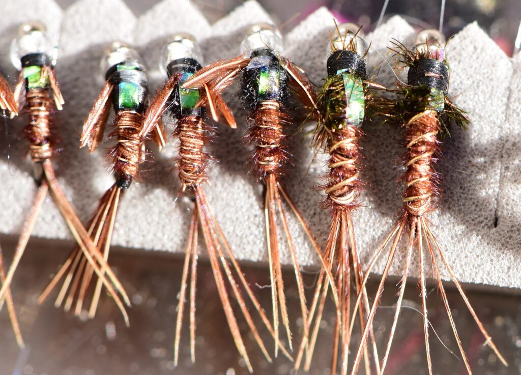 Row of hand-tied sinking flies with bead heads