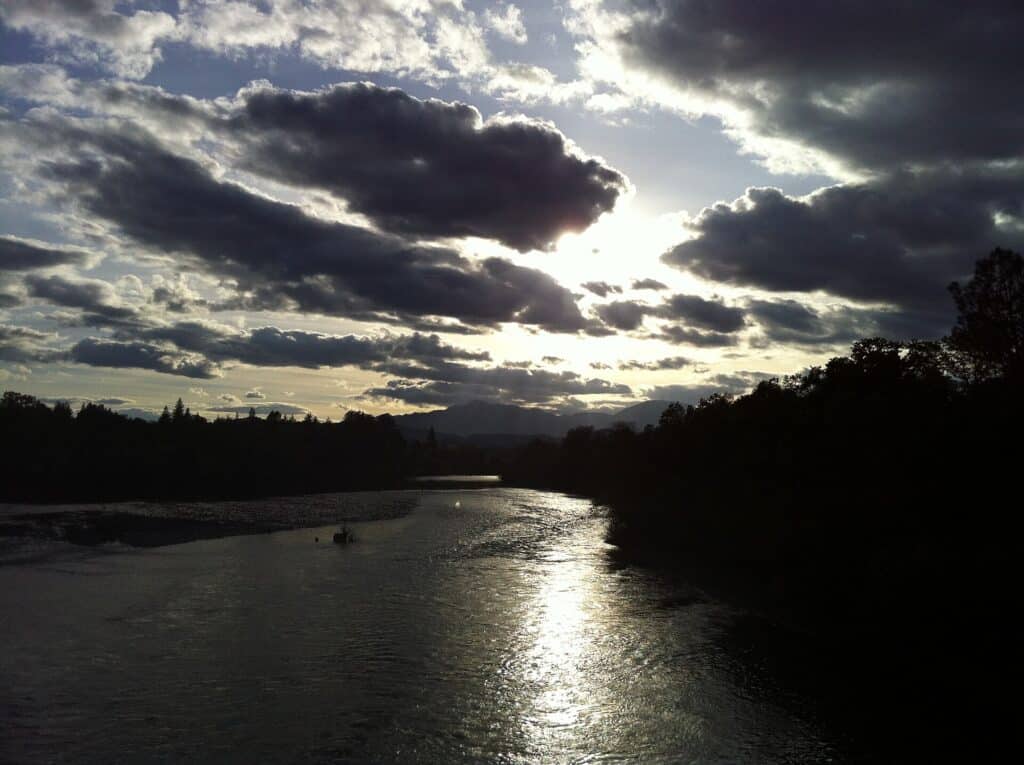 Sacramento River flowing through Redding beneath a cloudy sky