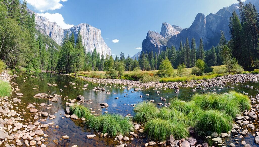 Merced River flowing through Yosemite Valley with Sierra cliffs beyond